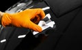 Car polish wax worker hands polishing car. Buffing and polishing vehicle with ceramic. Car detailing. Man holds a polisher in the Royalty Free Stock Photo