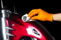 Car polish wax worker hands polishing motorcycle. Buffing and polishing vehicle with ceramic. Car detailing. Man holds a polisher Royalty Free Stock Photo