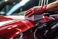 Car polishing series : Worker cleaning a red car with microfiber cloth, hand close up Car cleaning. Wash the red car with soap, AI Royalty Free Stock Photo