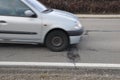 Car and pothole on road Royalty Free Stock Photo