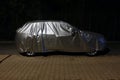 Car with protective cover at night