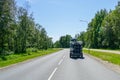 A car pulls a trailer with many rental fiberglass kayaks on an asphalt road, rear view Royalty Free Stock Photo