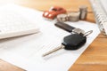 Car purchase concept. Car keys, calculator, toy car, coins and purchase contract Royalty Free Stock Photo