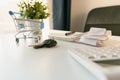 Car purchase concept. Empty shopping cart , car keys, calculator and notebook on white table Royalty Free Stock Photo