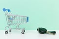 Car purchase concept. Empty shopping cart and car keys on white table with light blue background Royalty Free Stock Photo