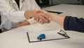 Car purchase deal. Seller and female buyer shaking hands. Royalty Free Stock Photo