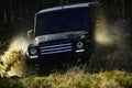 Car racing in autumn forest. Offroad race on fall nature background. Extreme, challenge and 4x4 vehicle concept. SUV or Royalty Free Stock Photo