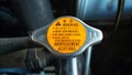 Car radiator cap with warning in many language, in english means translate \