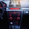 Car radio and air conditioner system. Button on dashboard in modern car panel. Royalty Free Stock Photo