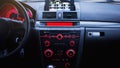 Car radio and air conditioner system. Button on dashboard in modern car panel. Royalty Free Stock Photo