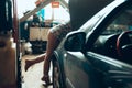 Car reapir, exam. Female auto mechanic working at auto service station using different work tools. Gender equality. Work Royalty Free Stock Photo