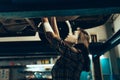 Car reapir, exam. Young pretty girl, auto mechanic working at auto service station using different work tools. Gender Royalty Free Stock Photo