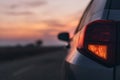 Car rear stop light in sunset, selective focus Royalty Free Stock Photo