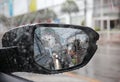 Car rear view mirror with blur raindrops Royalty Free Stock Photo