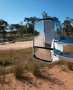 Car Rear View Mirror Of Caravan Towed Across A Dirt Road Royalty Free Stock Photo