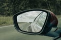 Car rearview mirror modern vehicle in road back view and cloudy sky Royalty Free Stock Photo