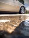 Car with reflection puddle in driveway Royalty Free Stock Photo