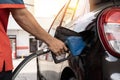 Car refueling on petrol station. Fuel pump at station. Refueling the car at a gas station fuel pump. Man driver hand refilling and Royalty Free Stock Photo