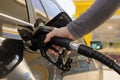 Car refuelling on the petrol station. Man refilling the car with fuel. Close up view. Gasoline, diesel is getting more Royalty Free Stock Photo