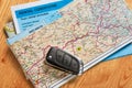 Car remote key, map and rental agreement Royalty Free Stock Photo