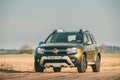 Car Renault Duster Or Dacia Duster Suv Parked On Field Country Road