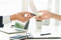 Close up view Hand of agent giving car key to customer after signed rental contract form Royalty Free Stock Photo