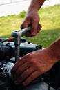 Car repair. Auto mechanic working on car engine in mechanics garage. Repair service. close-up shot Royalty Free Stock Photo