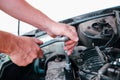 Car repair. Auto mechanic working on car engine in mechanics garage. Repair service. close-up shot Royalty Free Stock Photo