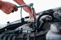 Car repair. Auto mechanic working on car engine in mechanics garage. Repair service. close-up shot Royalty Free Stock Photo