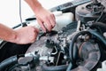 Car repair. Auto mechanic working on car engine in mechanics garage. Repair service. close-up shot Royalty Free Stock Photo