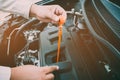 Car repair service, Auto mechanic checking oil level in a engine. Royalty Free Stock Photo