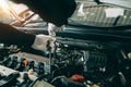 Car Repair service, Auto mechanic working in garage, Mechanic hands checking up of serviceability of the car in open hood, close Royalty Free Stock Photo