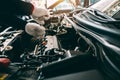 Car Repair service, Auto mechanic working in garage, Mechanic hands checking up of serviceability of the car in open hood, close Royalty Free Stock Photo