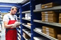 Car repair shop employees in the warehouse for spare parts for r Royalty Free Stock Photo