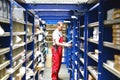 Car repair shop employees in the warehouse for spare parts for r