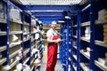 Car repair shop employees in the warehouse for spare parts for r Royalty Free Stock Photo