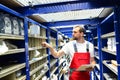 Car repair shop employees in the warehouse for spare parts for r Royalty Free Stock Photo