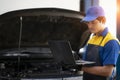 Car repair technicians use laptop computers to measure engine values for analysis Royalty Free Stock Photo