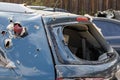 Car riddled with bullets. War of Russia against Ukraine. A car of civilians shot by the Russian military during the evacuation of Royalty Free Stock Photo