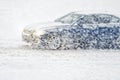 Car rides through a snowstorm