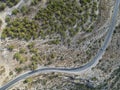 The car rides on a winding mountain road. Top down aerial view Royalty Free Stock Photo