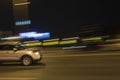 Car on the road driving fast through night city. Blurred city lights. Motion blur background Royalty Free Stock Photo