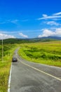 Car on road and Green grass with blue sky at Klong Haeng Reservoir Krabi