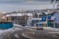 The car on the road, the residential neighborhood and the old wooden buildings in Ulan-Ude, Buryatia, Russia.