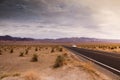 landscape with a road crossing the desert of death valley in California with the mountains in the background Royalty Free Stock Photo