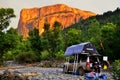 Car with roof tents camping in a riverbed with Cathedral rock in the background lit up by the sunset..25/04/2010 - Marrakech, Royalty Free Stock Photo