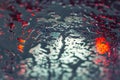 Car running through automatic carwash. Windscreen view from inside. Abstract wet windshield background. Red brake lights of car Royalty Free Stock Photo