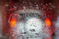 Car running through automatic carwash. Windscreen view from inside. Abstract wet windshield background. Red brake lights of car Royalty Free Stock Photo