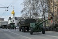 Car of Russian army against background of white chapel. Military equipment drives through the empty streets of city.