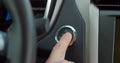 Car`s ignition button is getting pushed to start and stop the vehicle. pushing power ignition button to start keyless